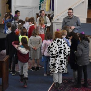 Photo of worship service when kids are leaving the sanctuary for Faith Formation